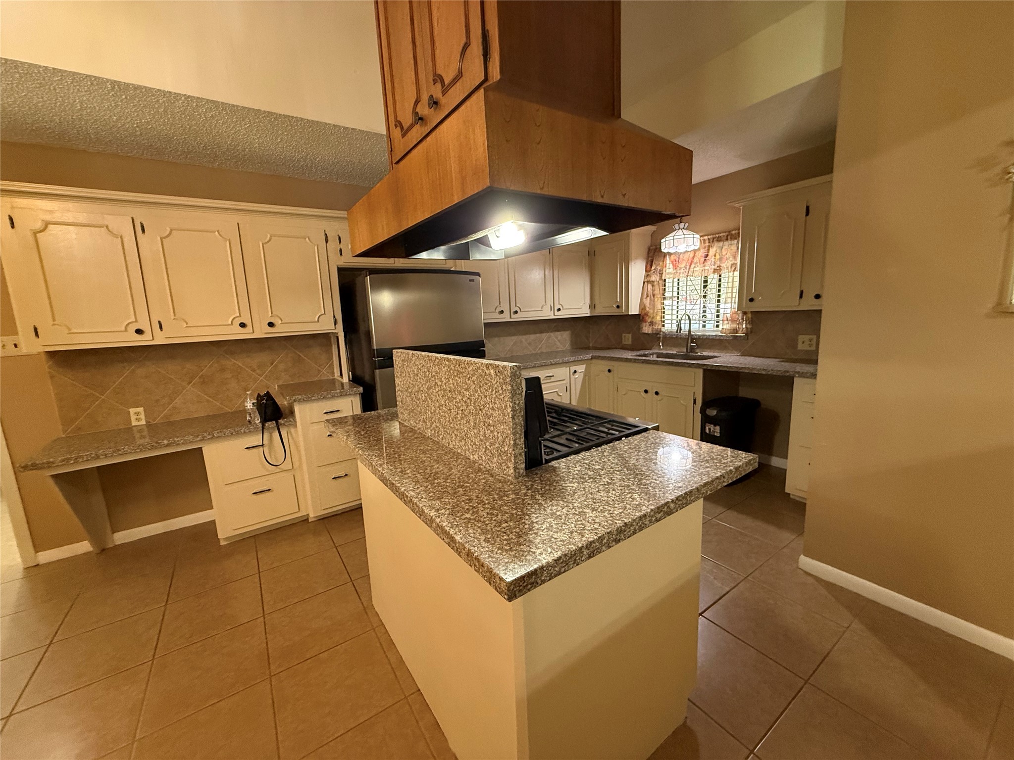 4114 Connorvale Road Houston, TX 77039 - Photo 9 of 18 a kitchen with a stove a sink a microwave and cabinets