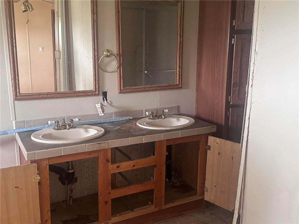 749 Chambers Road Commerce, GA 30530 - Photo 6 of 13 a bathroom with a sink and a mirror