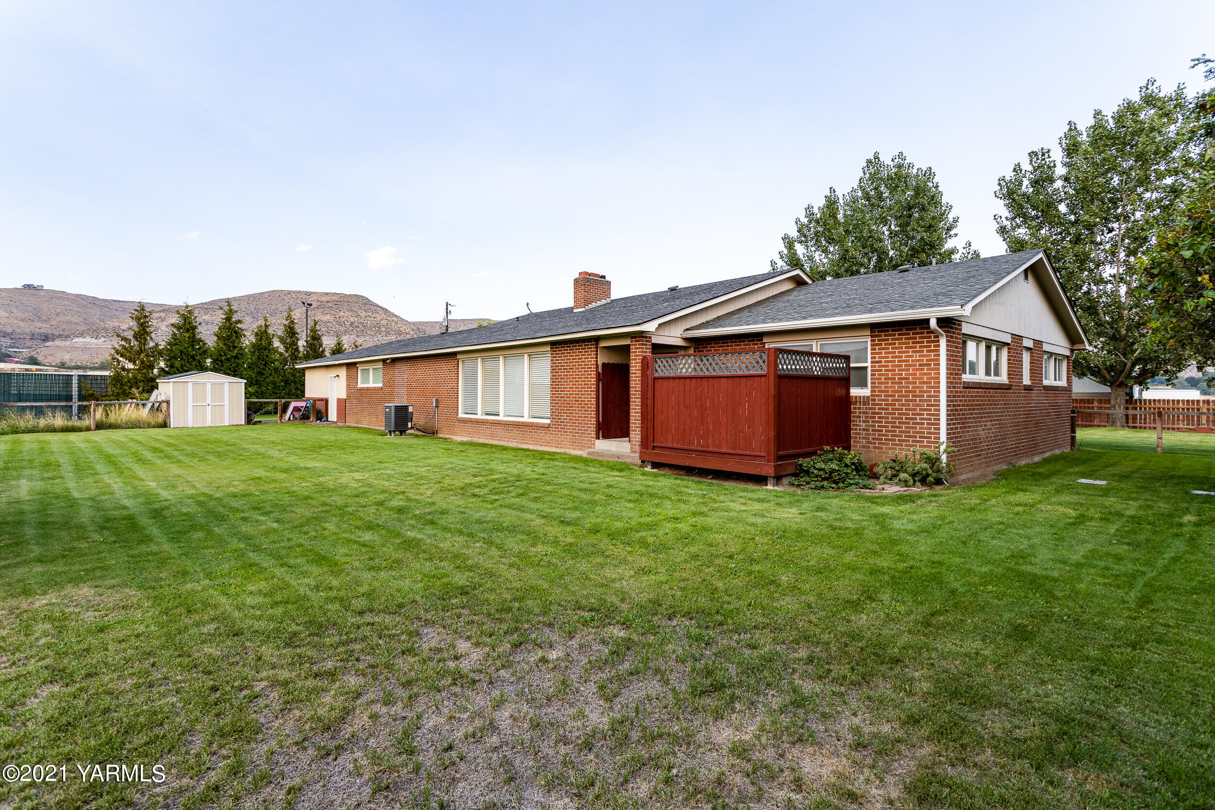 550 McPhee Road Naches, WA 98937 - Photo 23 of 28 a view of a house with a backyard