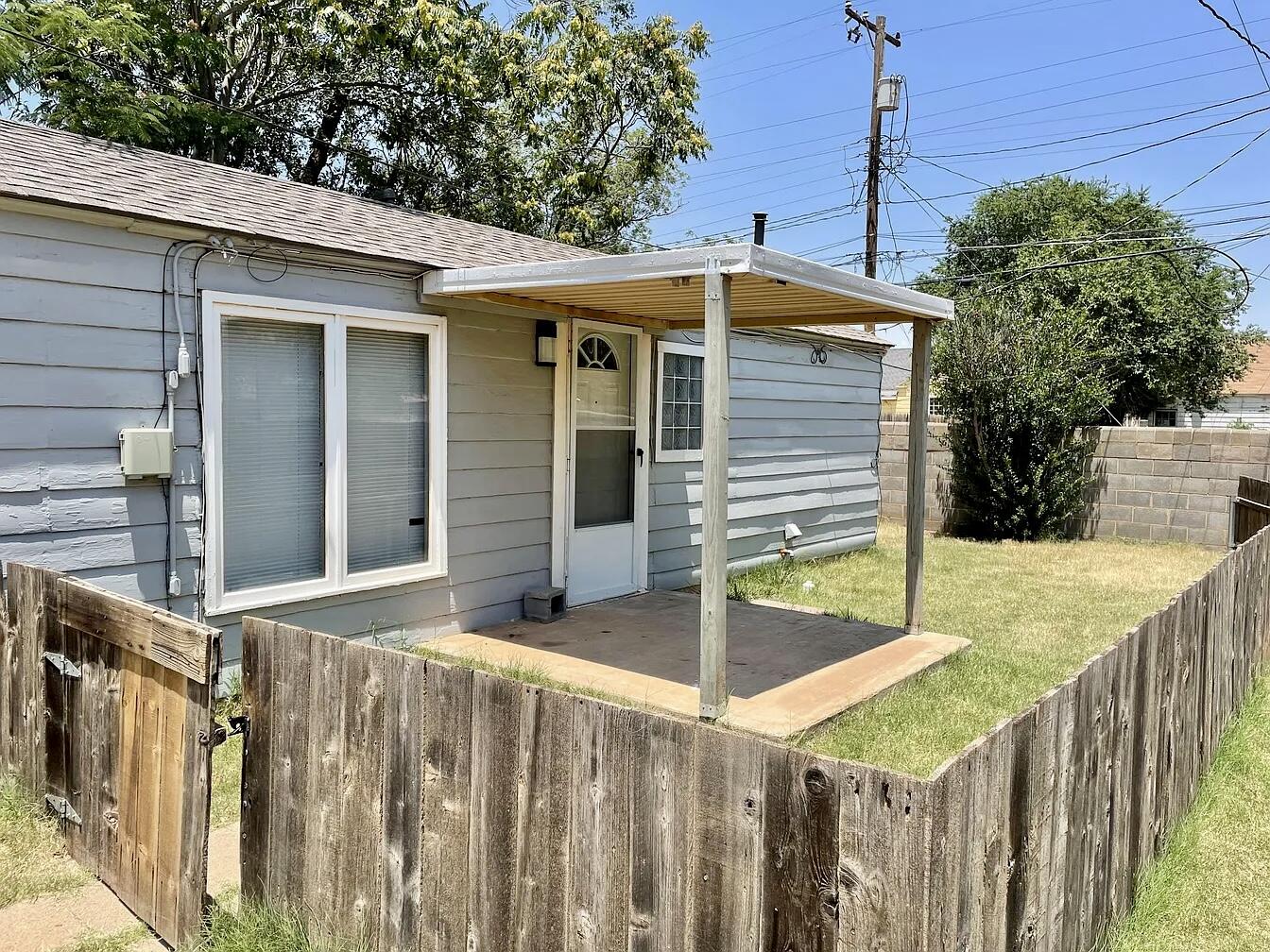 2216 30th Street, Unit REAR Lubbock, TX 79411 - Photo 1 of 14 a front view of house yard with wooden fence