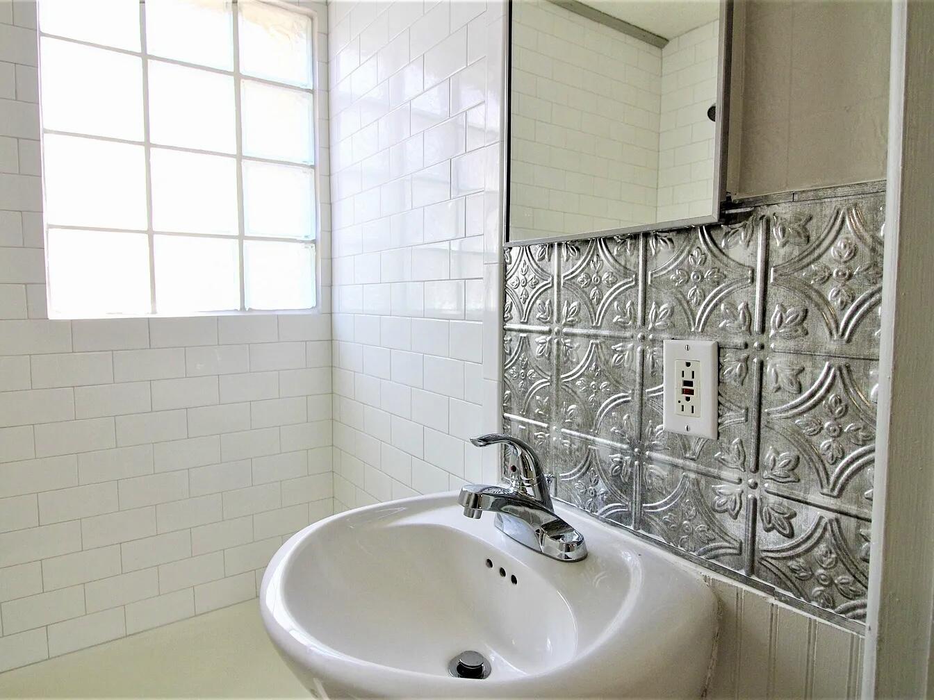 2216 30th Street, Unit REAR Lubbock, TX 79411 - Photo 13 of 14 a bathroom with a sink and a bathtub