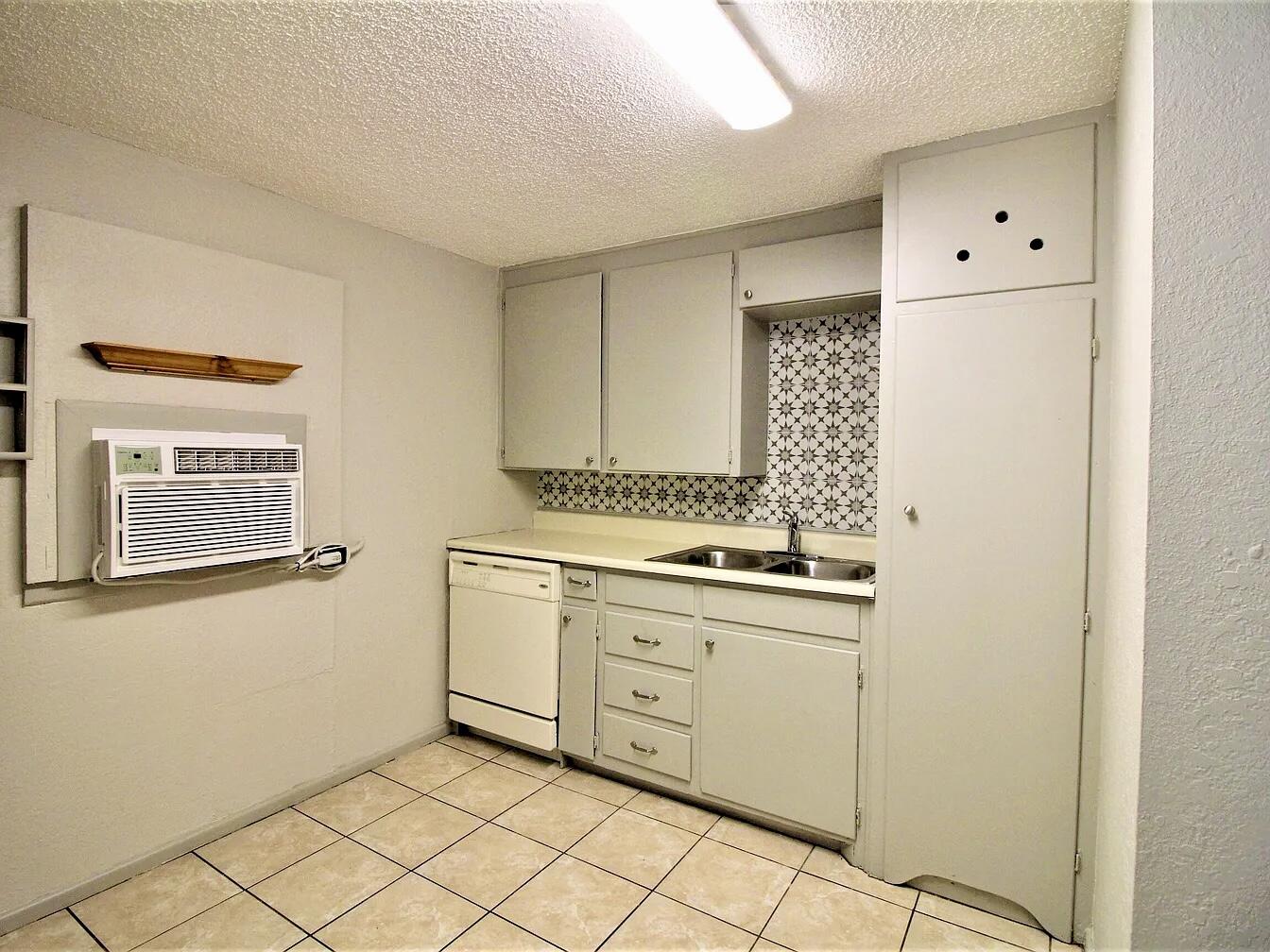 2216 30th Street, Unit REAR Lubbock, TX 79411 - Photo 7 of 14 a utility room with cabinets washer and dryer