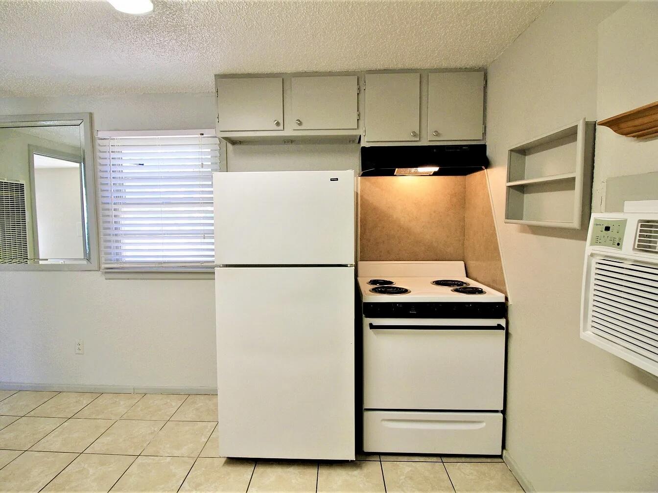 2216 30th Street, Unit REAR Lubbock, TX 79411 - Photo 8 of 14 a kitchen with a refrigerator and a stove