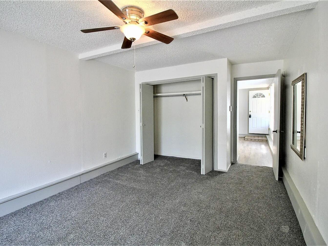 2216 30th Street, Unit REAR Lubbock, TX 79411 - Photo 10 of 14 an empty room and chandelier fan