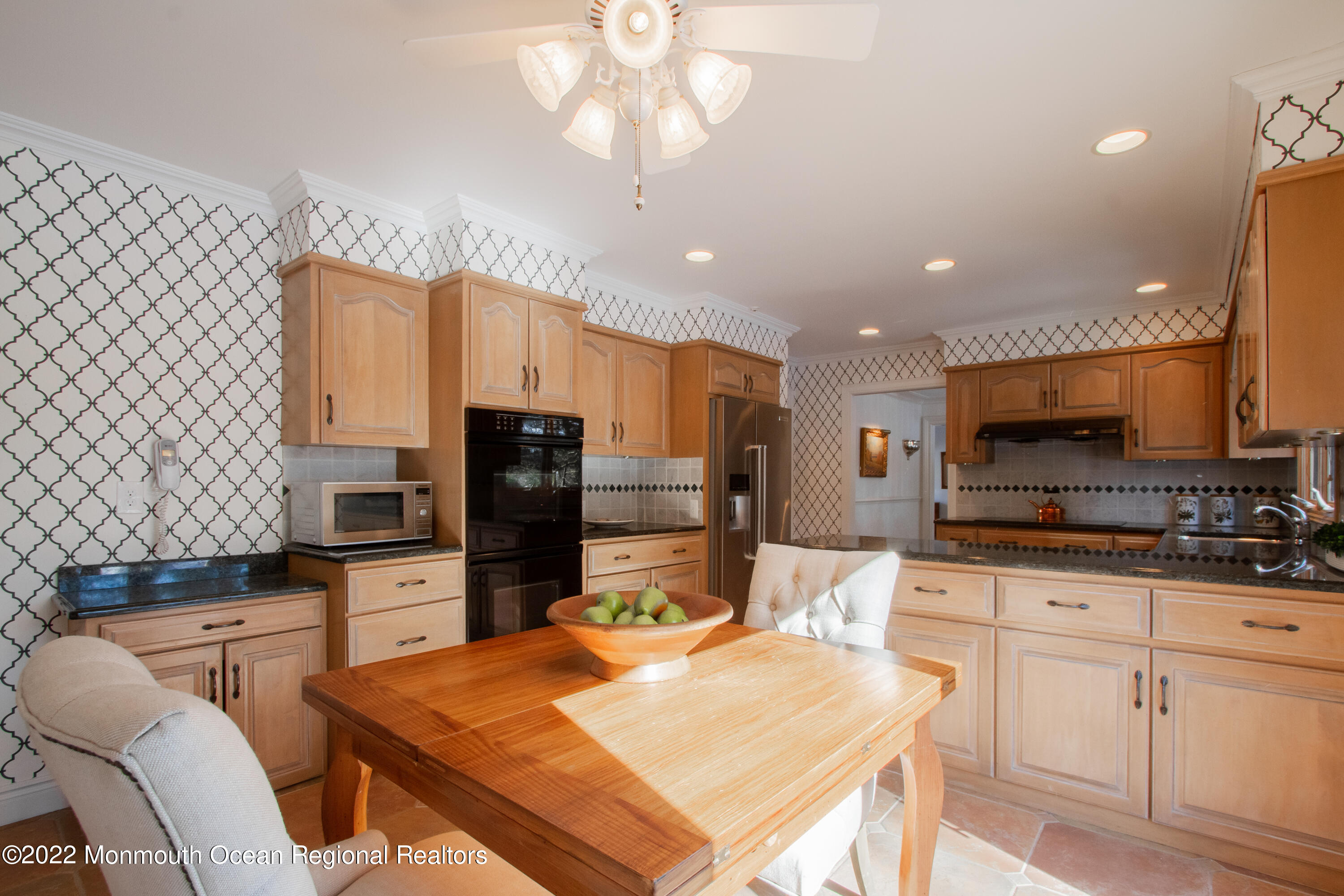 2 Woods End Road Rumson, NJ 07760 - Photo 16 of 35 a kitchen with stainless steel appliances granite countertop a stove top oven a sink a dining table and chairs