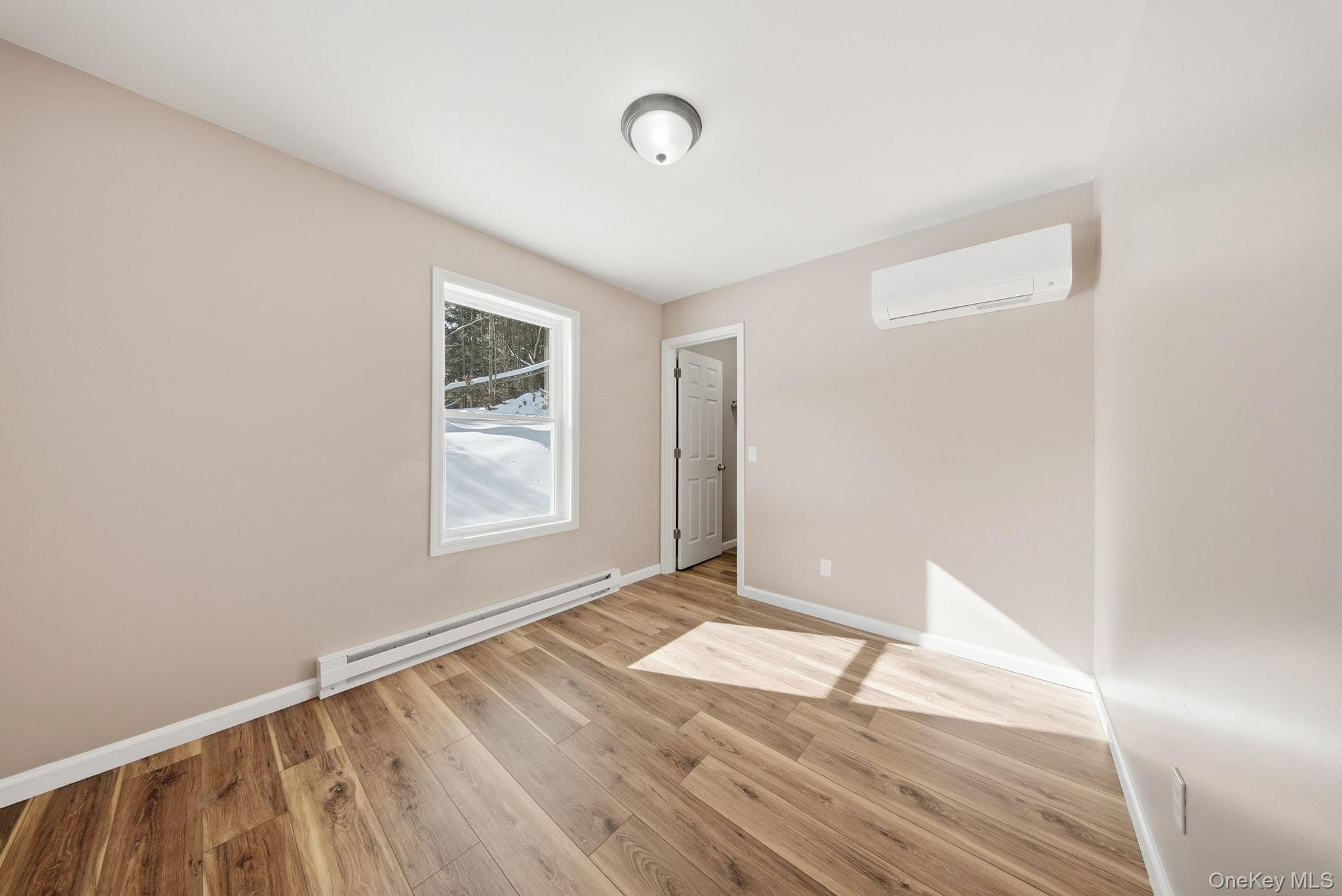 943 State Rte 55 Eldred, NY 12732 - Photo 17 of 33 a view of an empty room with wooden floor and a window