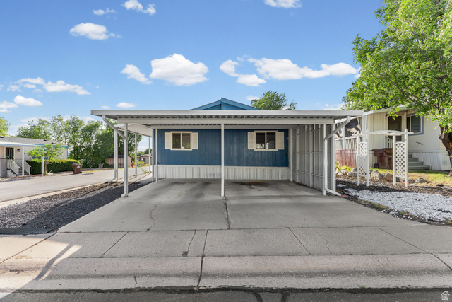 312 Harriger Way Layton, UT 84041 - Photo 27 of 36 Carport with concrete driveway and gravel landscaping