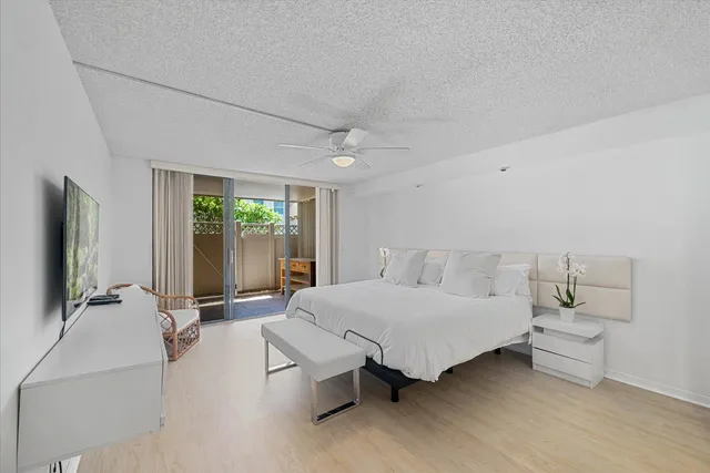 a bedroom with a bed and large window