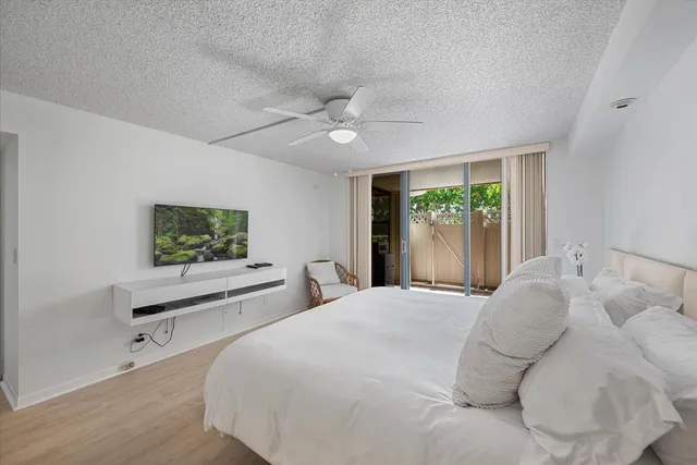 a large bed sitting in a bedroom next to a window