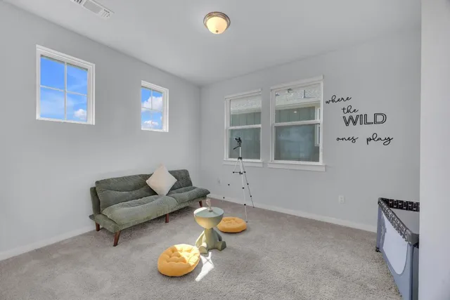 a bedroom with a bed and a flat tv screen on the dresser