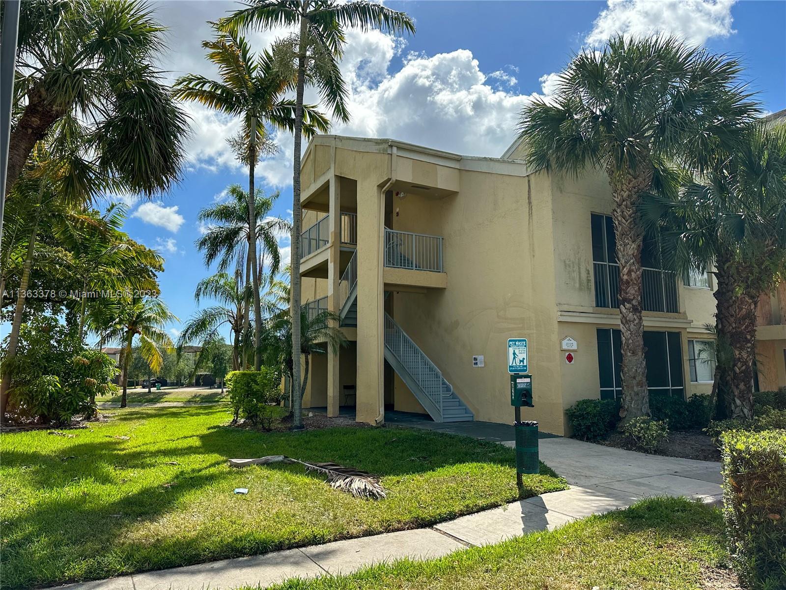 5654 Rock Island Road, Unit 234 Tamarac, FL 33319 - Photo 1 of 10 a front view of house with yard and green space