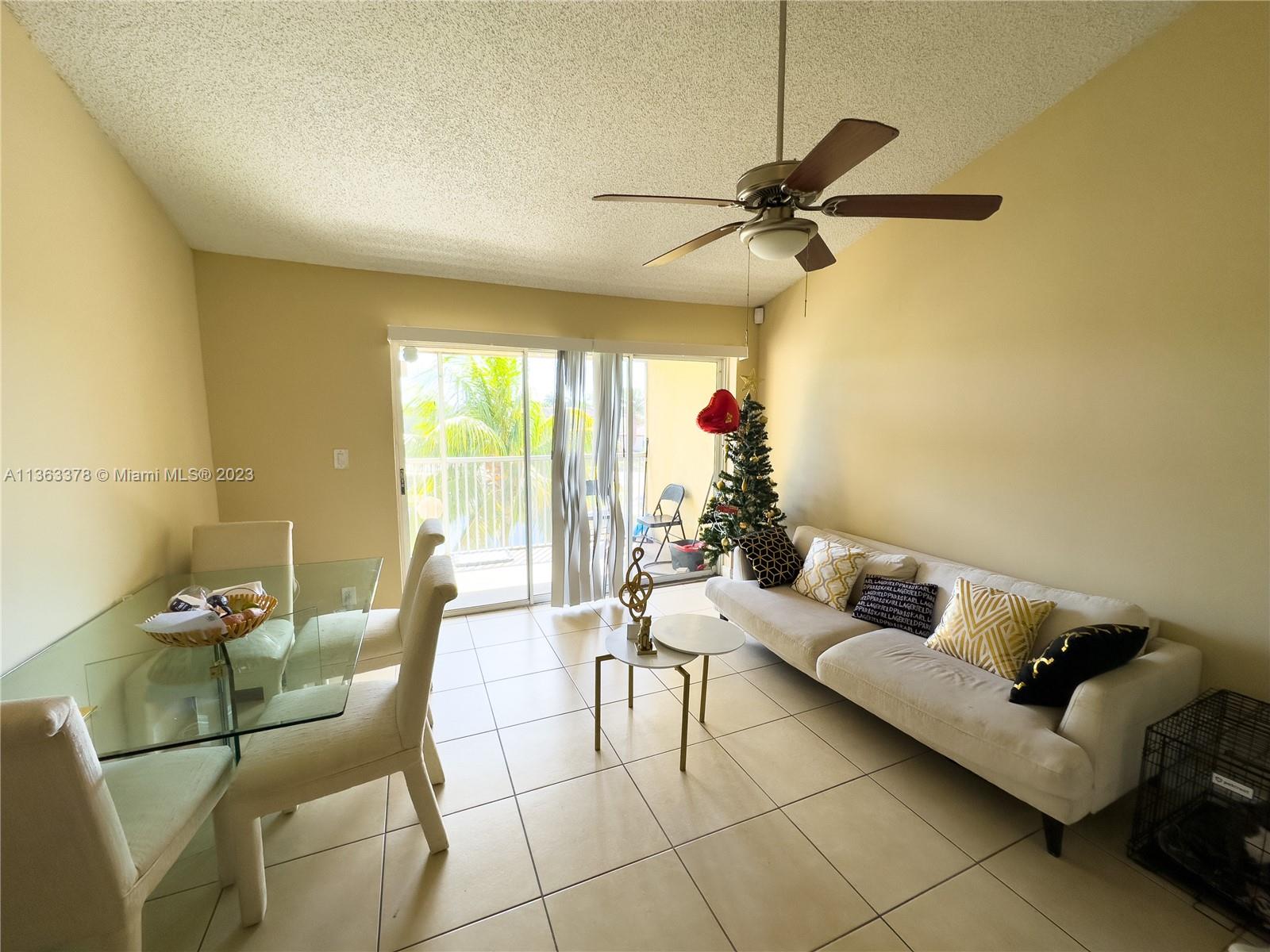 5654 Rock Island Road, Unit 234 Tamarac, FL 33319 - Photo 2 of 10 a living room with furniture and a window