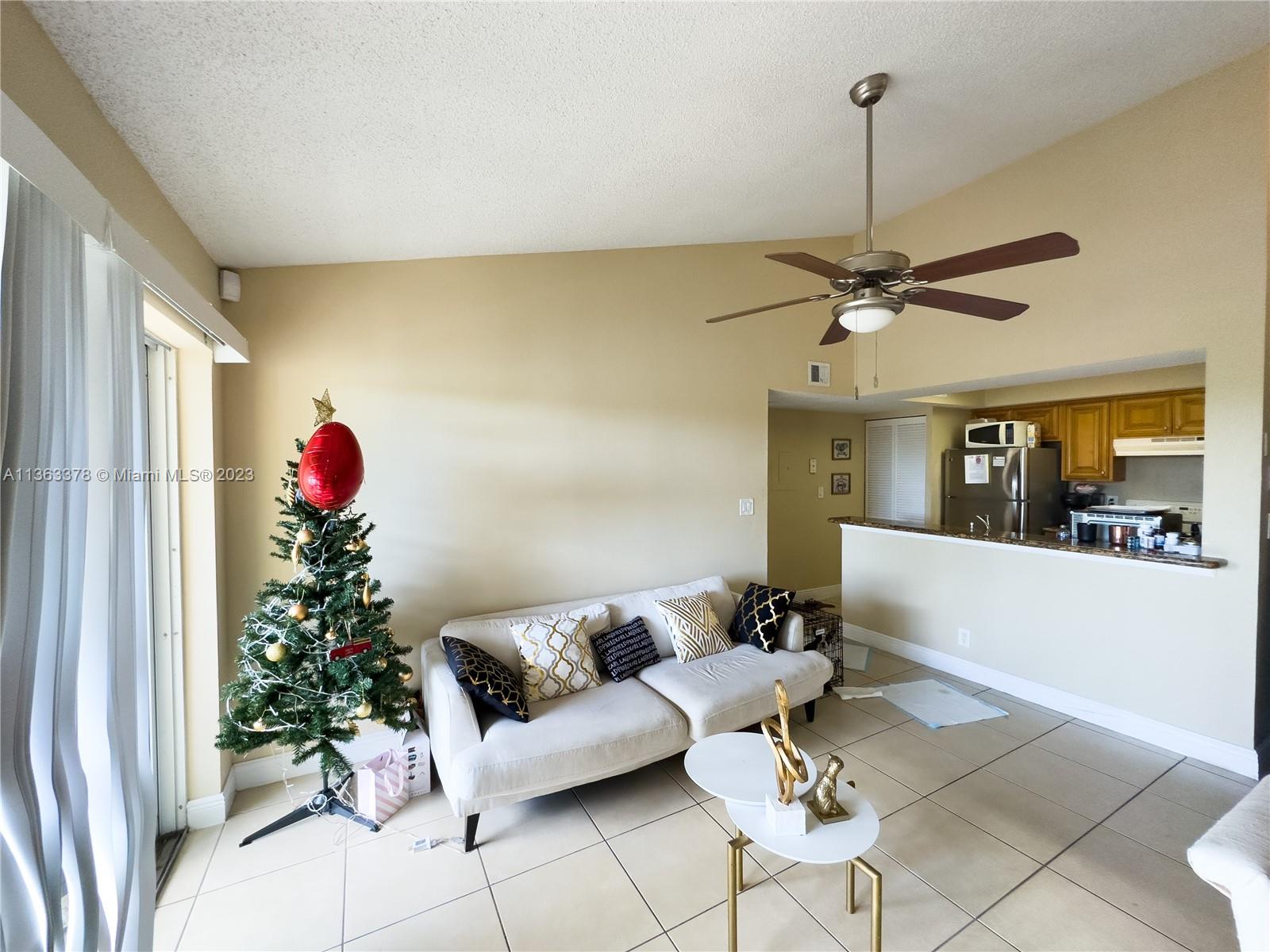 5654 Rock Island Road, Unit 234 Tamarac, FL 33319 - Photo 3 of 10 a living room with furniture and a chandelier