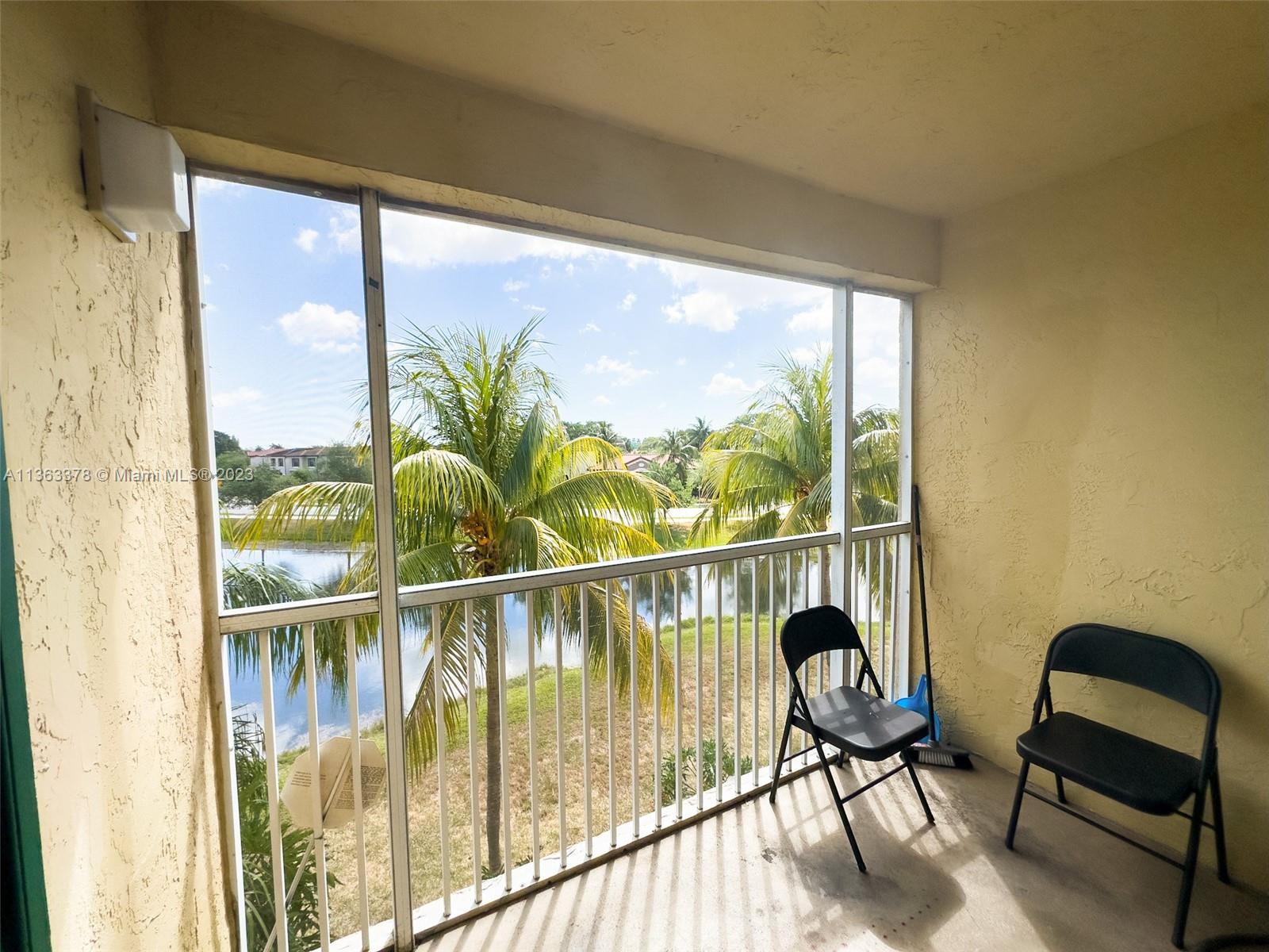 5654 Rock Island Road, Unit 234 Tamarac, FL 33319 - Photo 6 of 10 a view of a chairs and table in a balcony