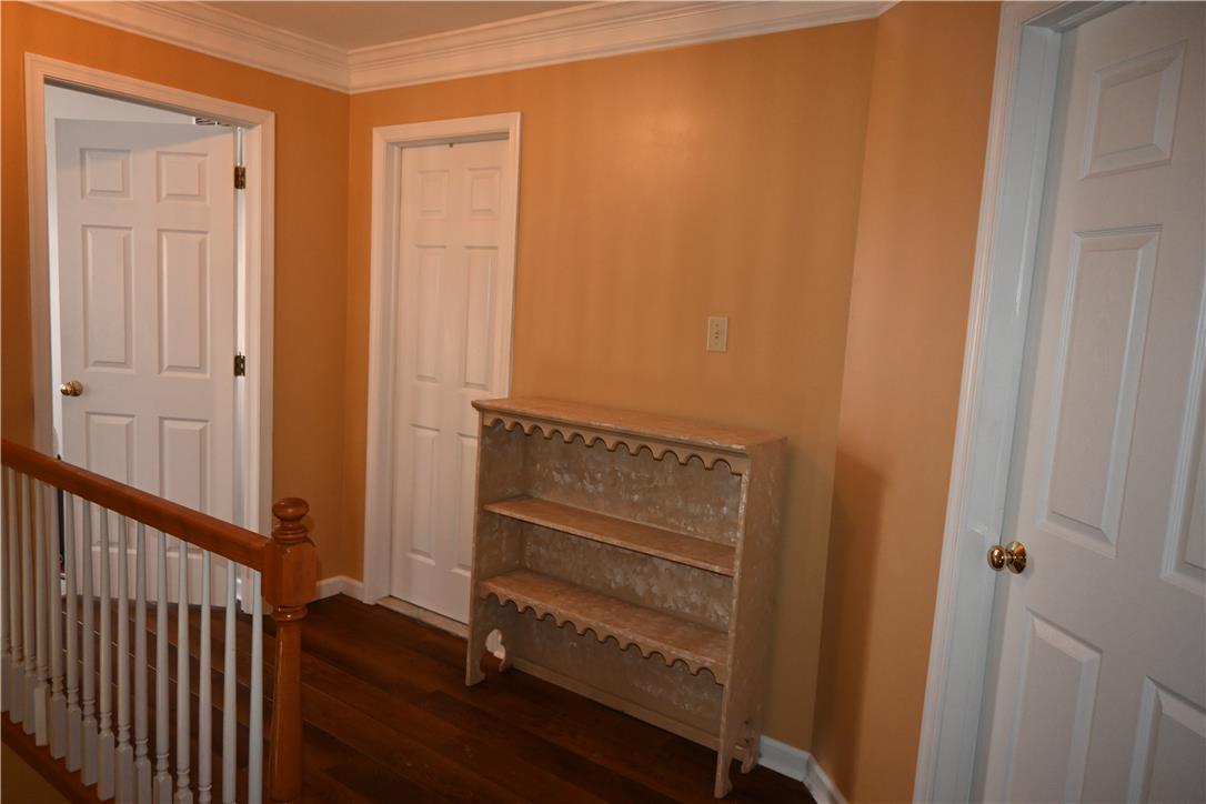 3829 East Hopewell Road Center Valley, PA 18034 - Photo 26 of 52 An inviting hallway featuring rich wood flooring and classic crown molding.