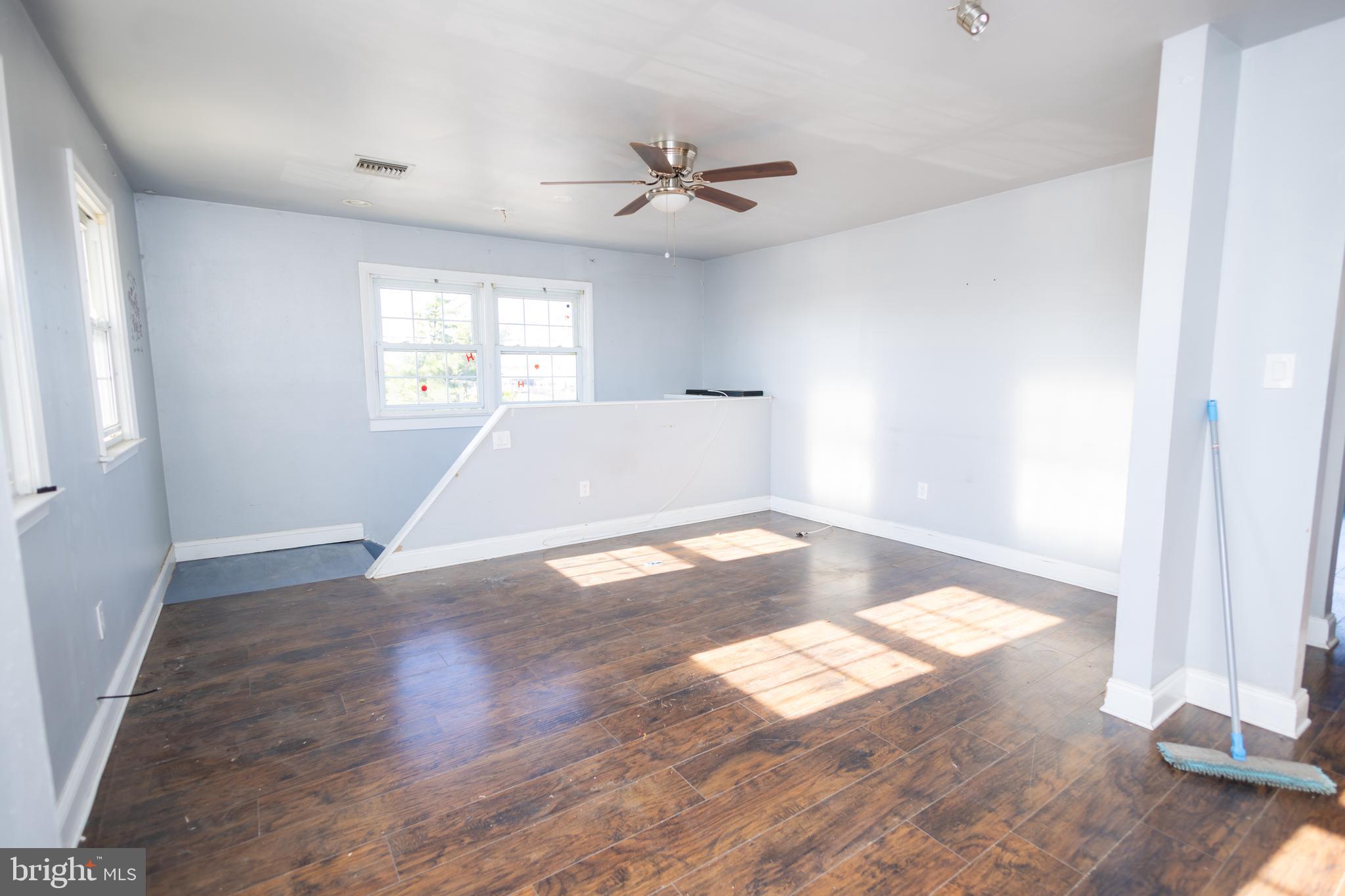 3201 Morrell Avenue, Unit 3 Philadelphia, PA 19114 - Photo 20 of 42 an empty room with wooden floor and windows