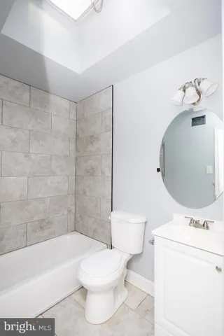 a bathroom with a toilet a sink and bathtub