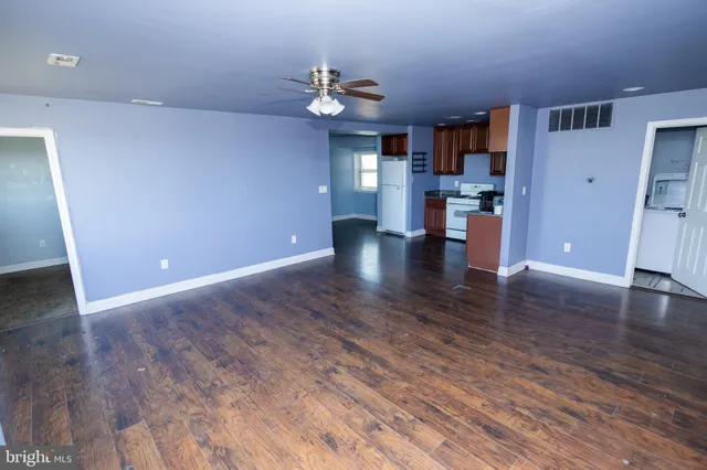 a view of a kitchen with wooden floor and a kitchen