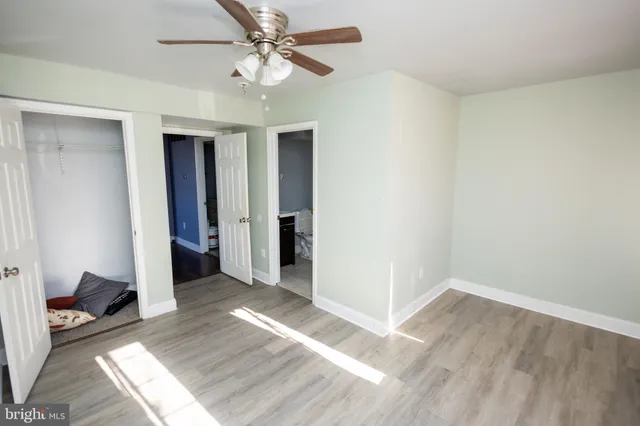 a view of hallway with wooden floor