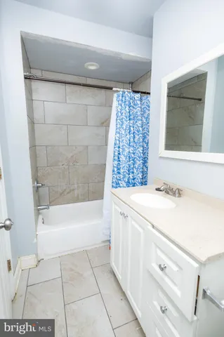 a bathroom with a sink a bathtub and a shower