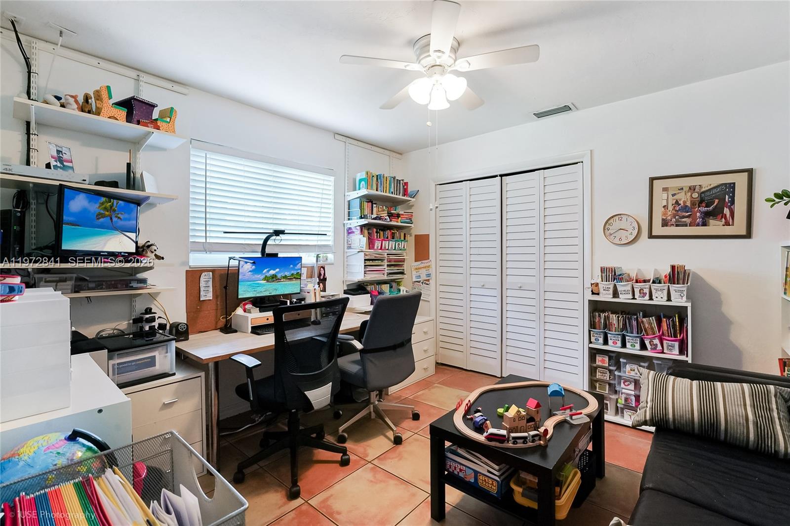 9860 Southwest 122nd Street Miami, FL 33176 - Photo 18 of 27 a living room with furniture a rug and a bookshelf