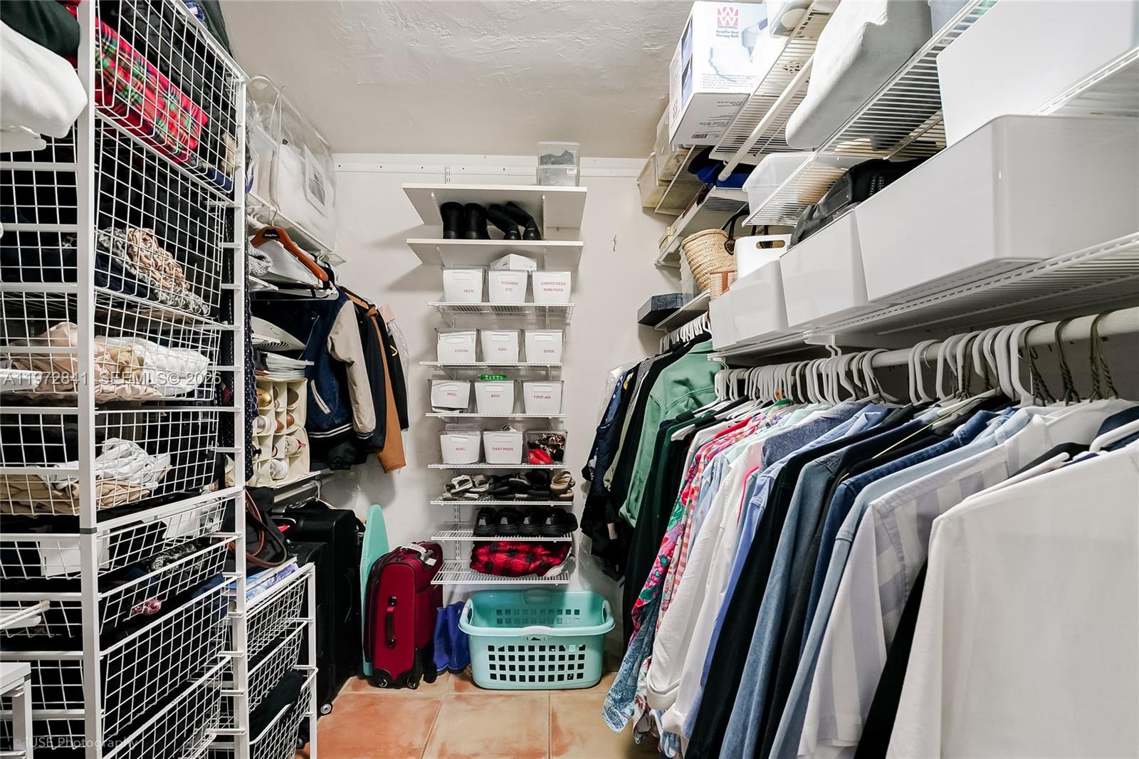 9860 Southwest 122nd Street Miami, FL 33176 - Photo 19 of 27 a view of walk in closet with clothes and shoes