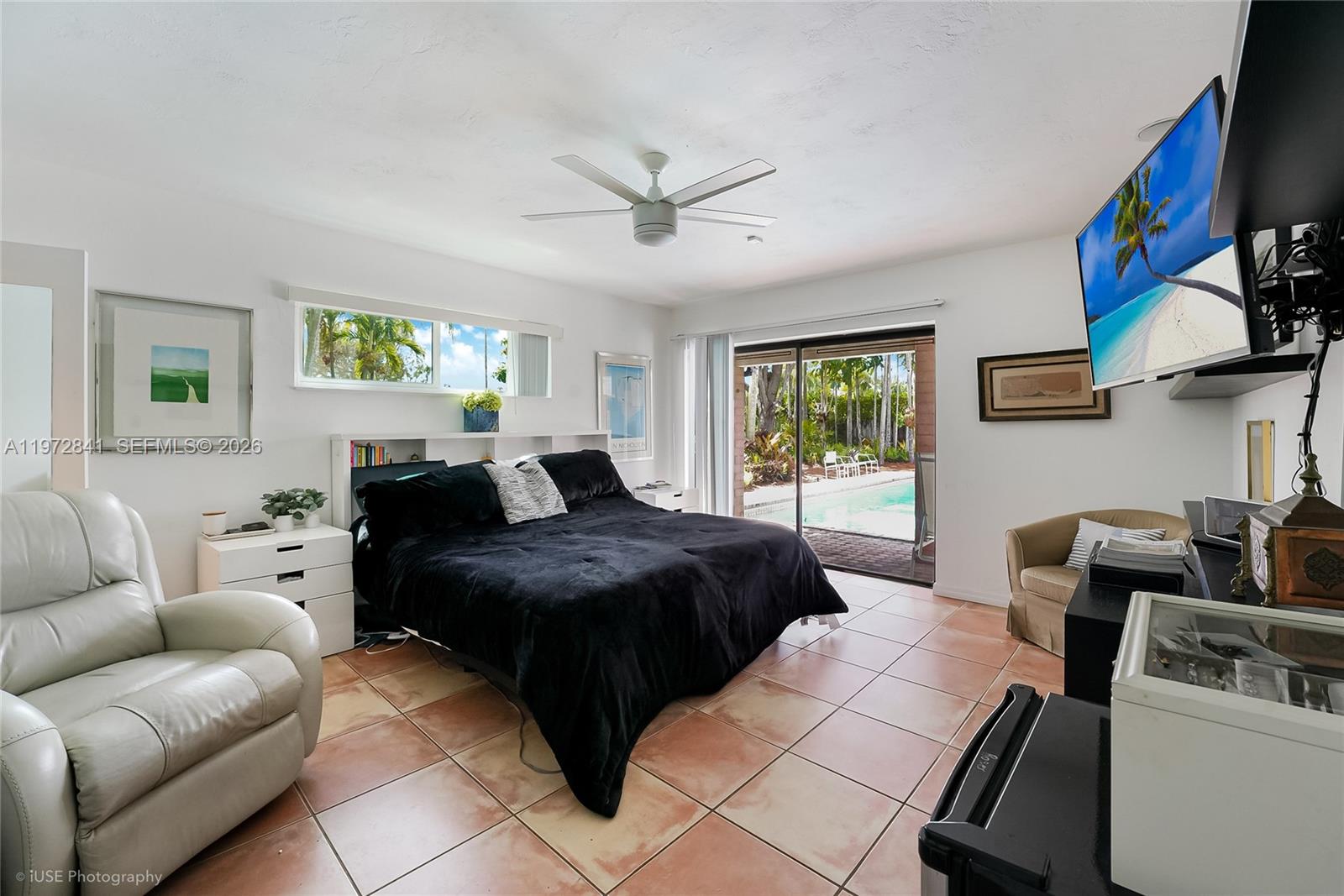 9860 Southwest 122nd Street Miami, FL 33176 - Photo 20 of 27 a bedroom with a bed a couch and a window