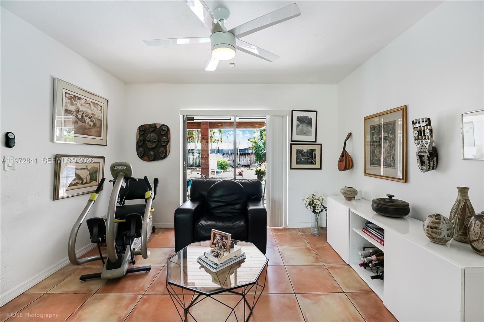 9860 Southwest 122nd Street Miami, FL 33176 - Photo 9 of 27 a living room with furniture and a flat screen tv