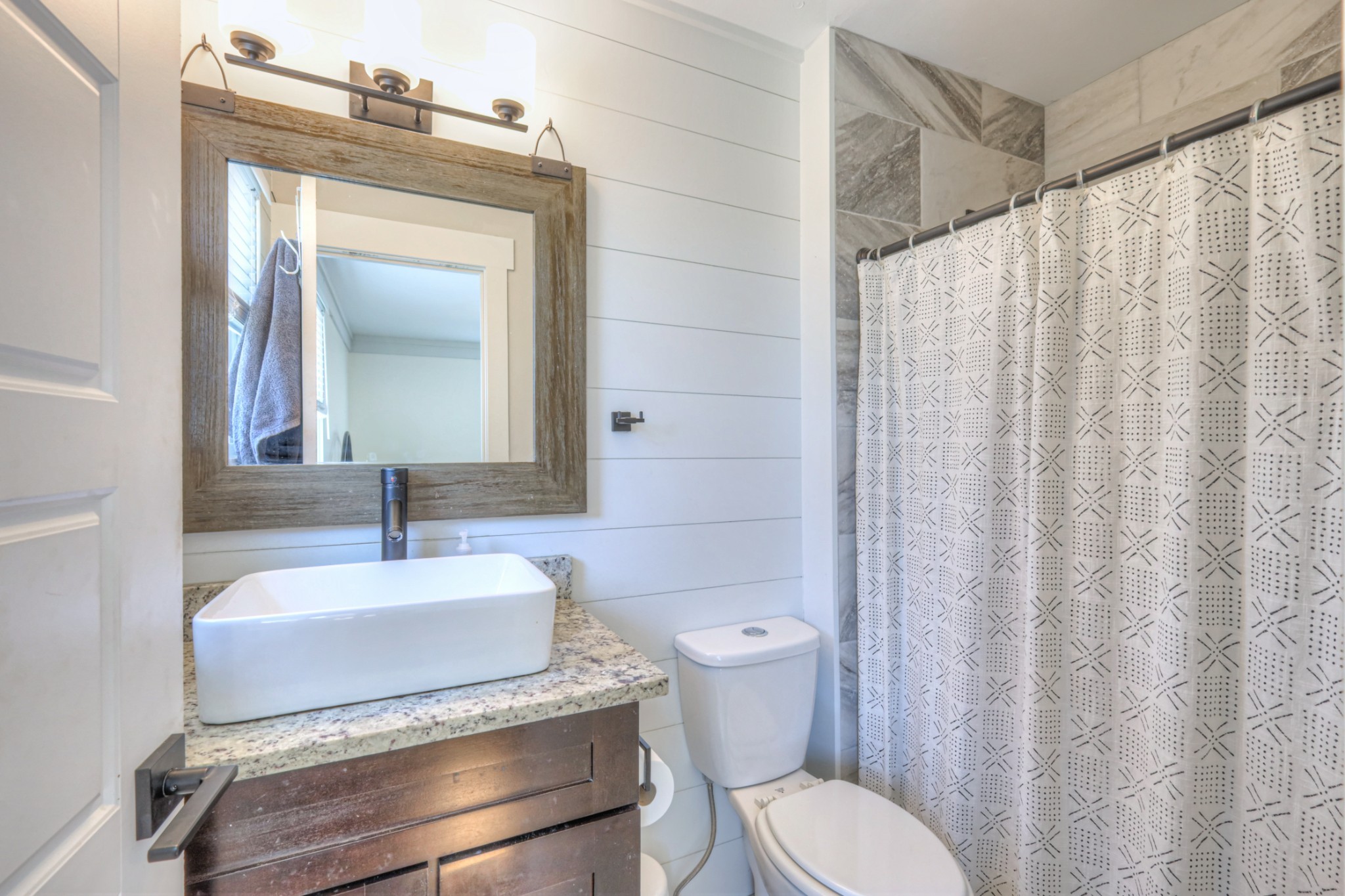 691 Harding Place Nashville, TN 37211 - Photo 14 of 54 a bathroom with a granite countertop sink vanity mirror and toilet