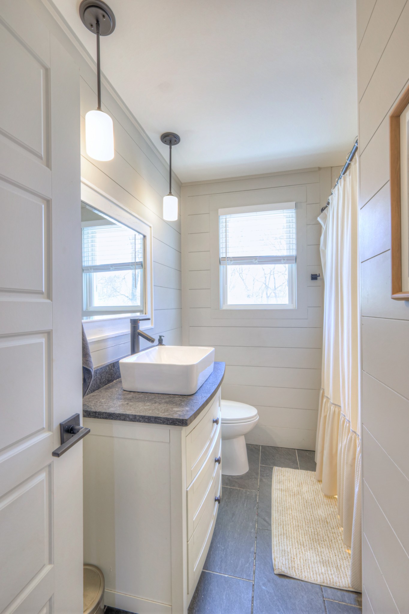 691 Harding Place Nashville, TN 37211 - Photo 19 of 54 a bathroom with a sink a toilet a mirror and a window