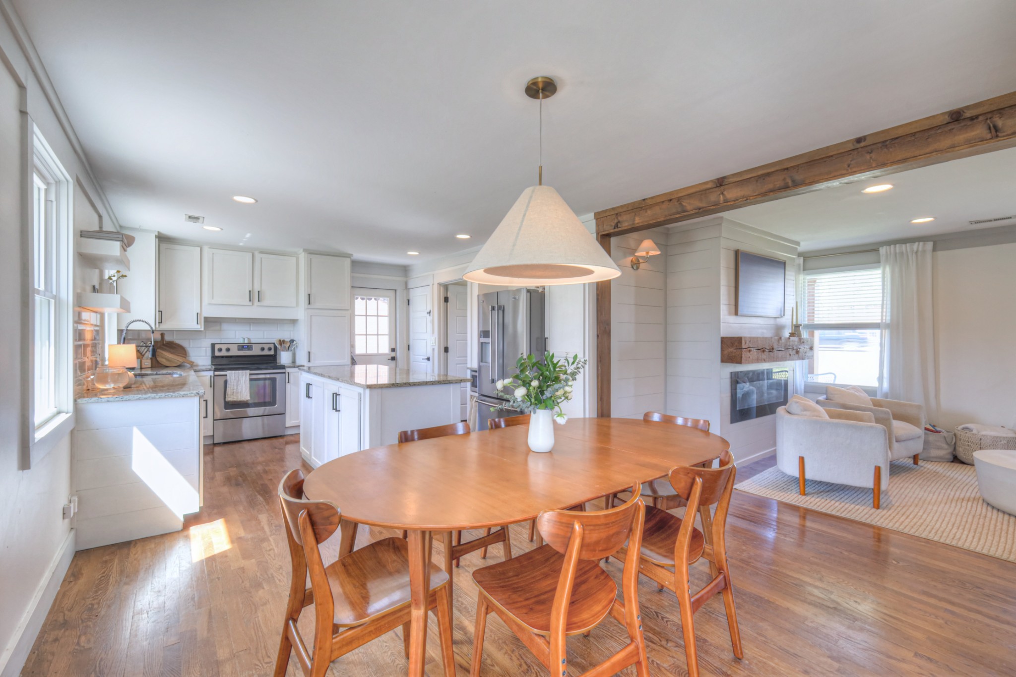 691 Harding Place Nashville, TN 37211 - Photo 22 of 54 a dining room with furniture a kitchen and chandelier