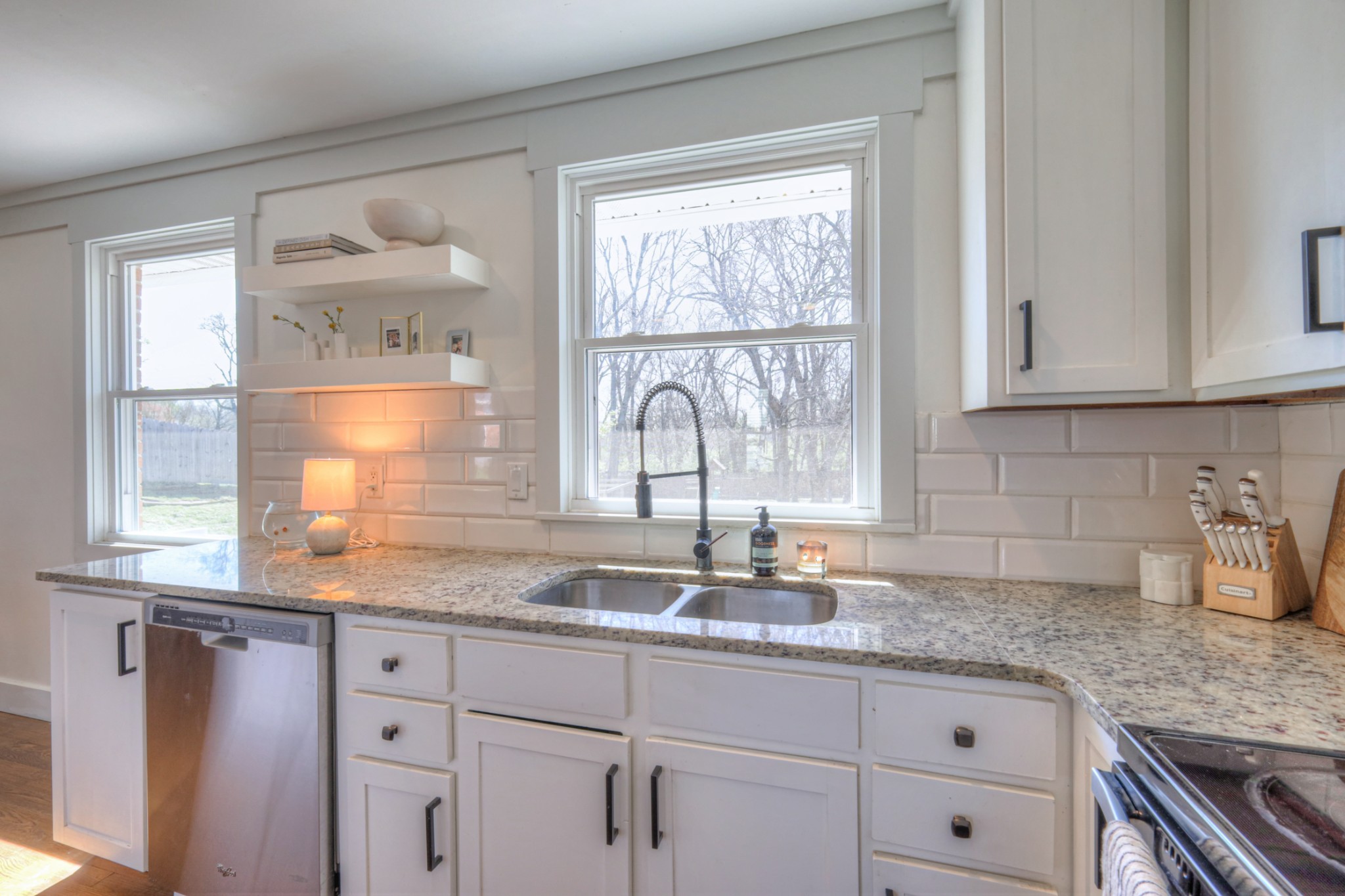 691 Harding Place Nashville, TN 37211 - Photo 27 of 54 a kitchen with granite countertop white cabinets and a window