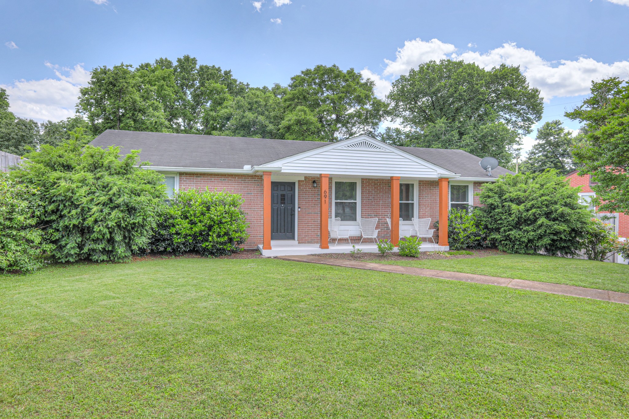 691 Harding Place Nashville, TN 37211 - Photo 3 of 54 a patio with a table and chairs under an umbrella