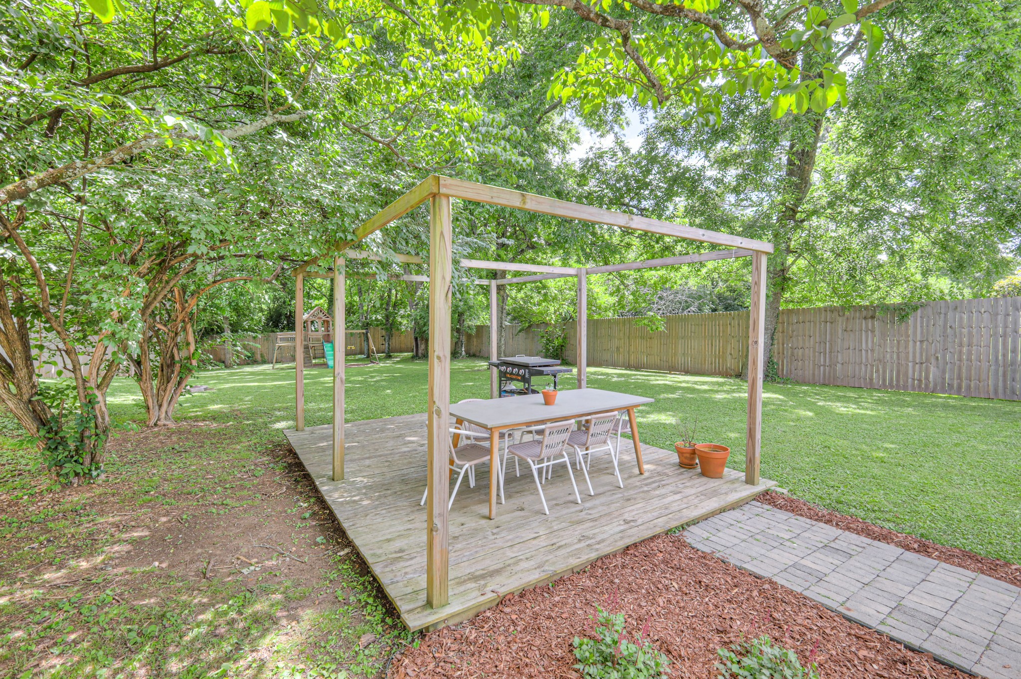 691 Harding Place Nashville, TN 37211 - Photo 41 of 54 a view of a chair and tables in the backyard