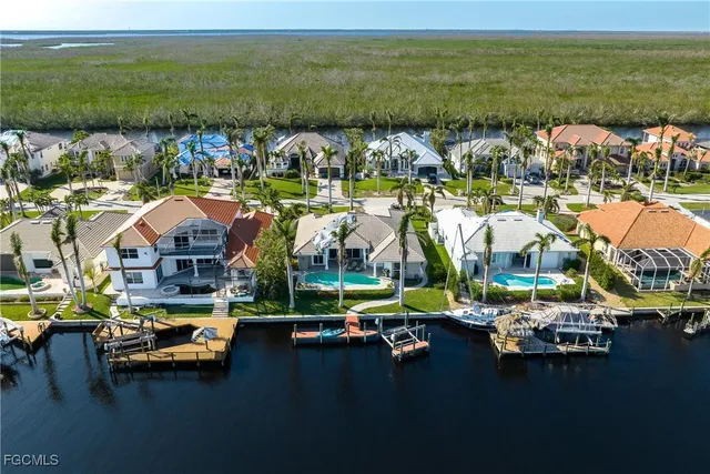 a view of a lake with lawn chairs