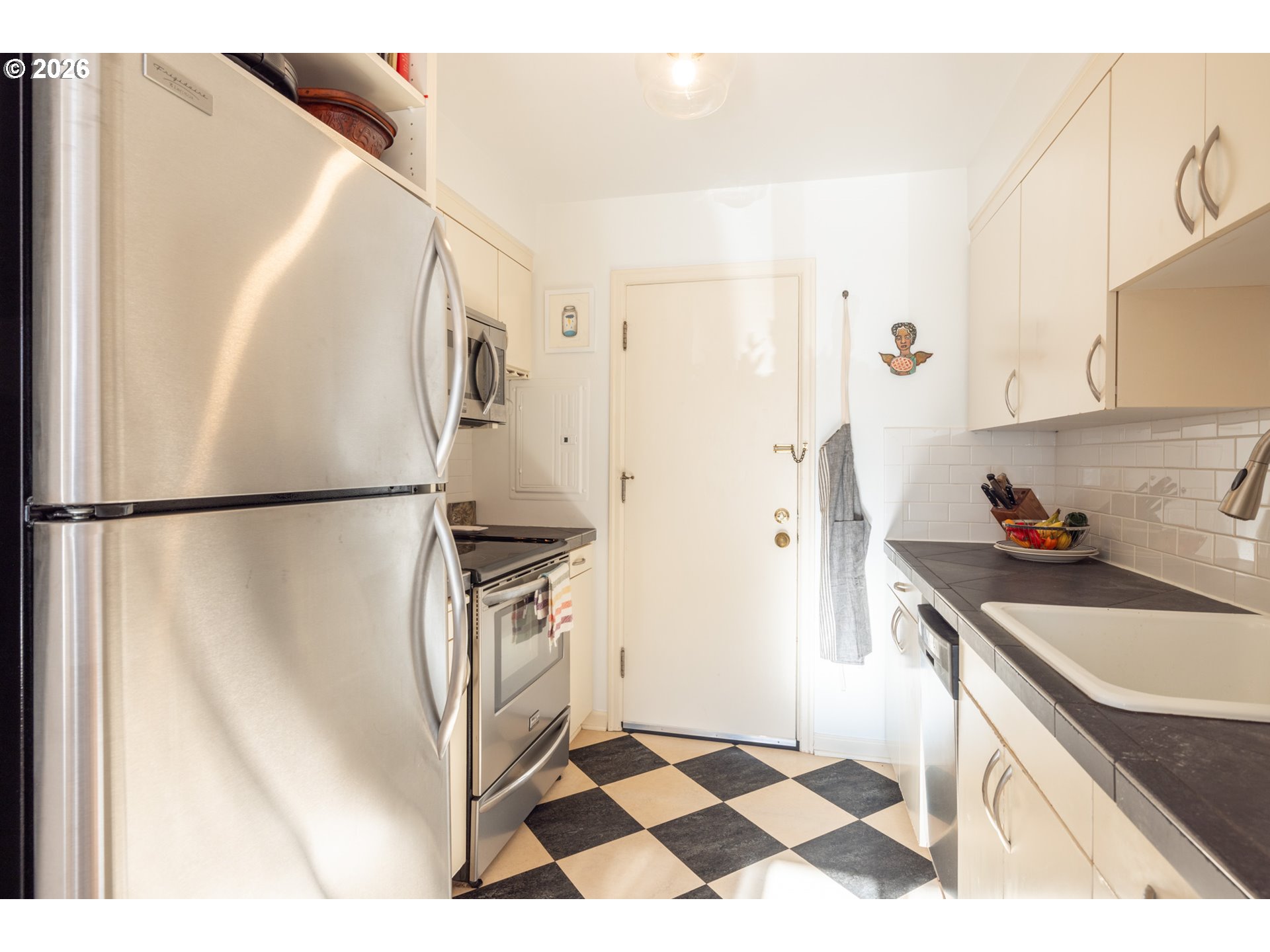 2123 Northeast Clackamas Street, Unit 5 Portland, OR 97232 - Photo 14 of 31 a kitchen with stainless steel appliances granite countertop a sink and a refrigerator