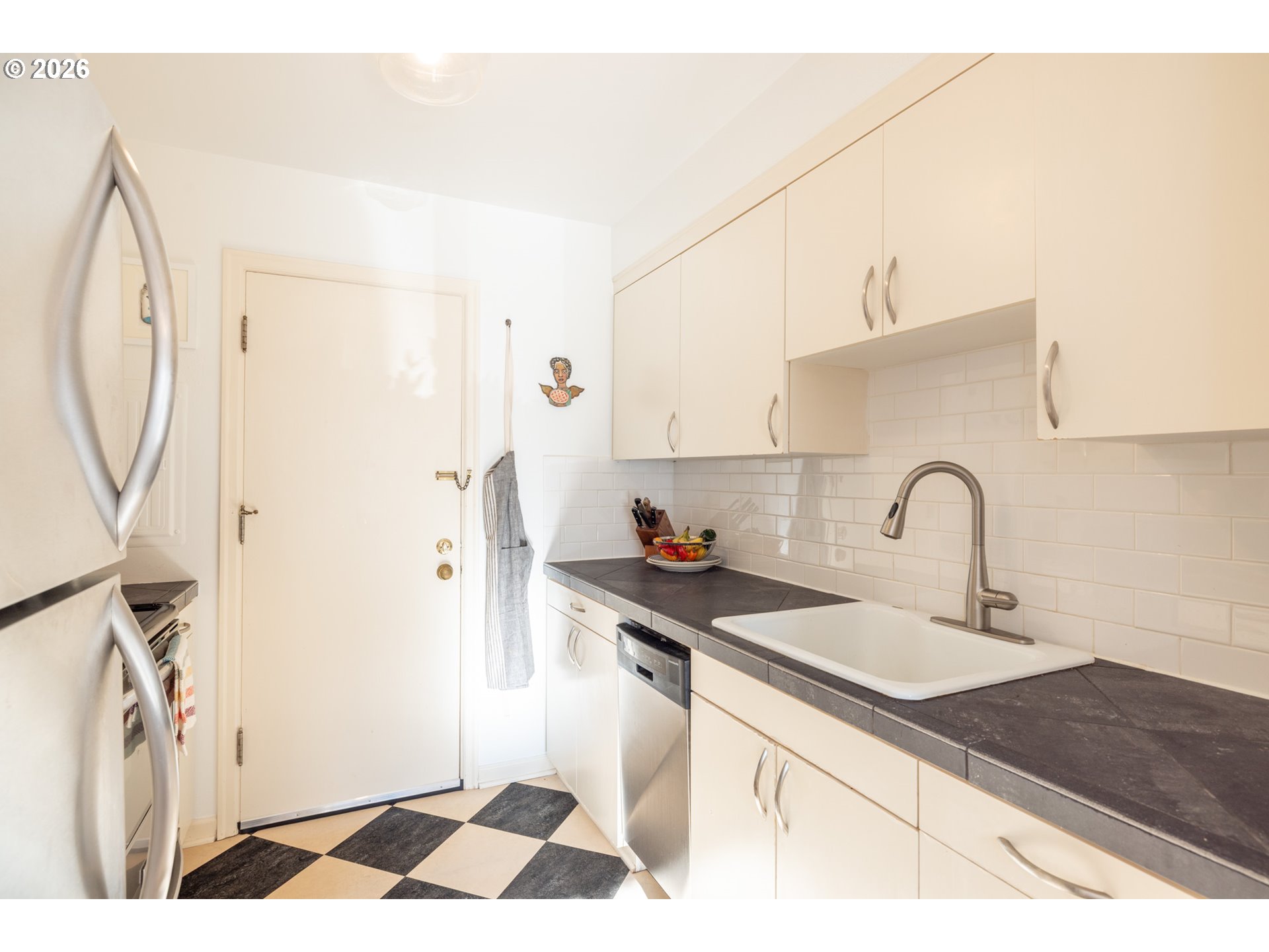 2123 Northeast Clackamas Street, Unit 5 Portland, OR 97232 - Photo 15 of 31 a kitchen with a sink and a refrigerator