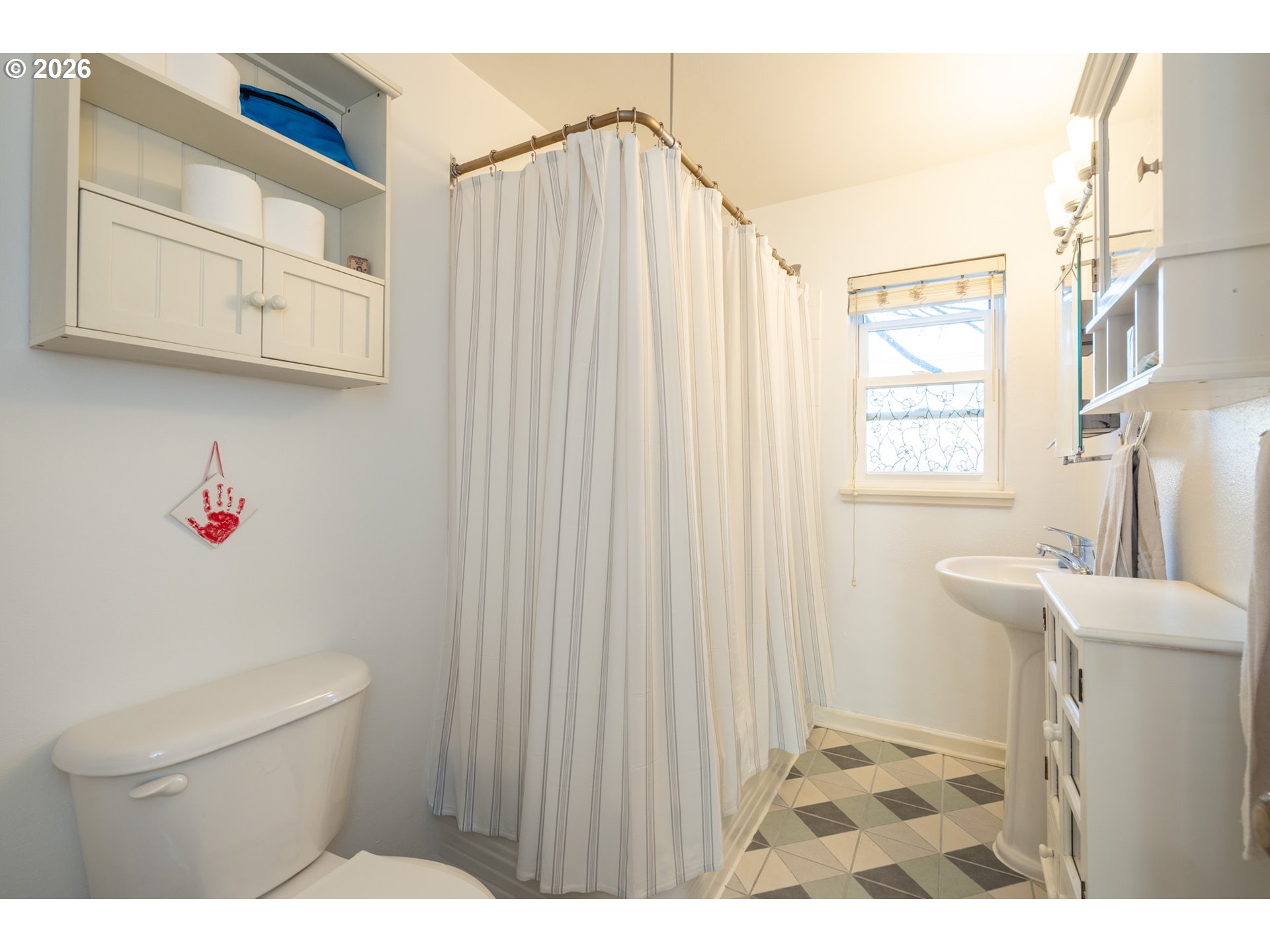 2123 Northeast Clackamas Street, Unit 5 Portland, OR 97232 - Photo 21 of 31 a bathroom with a sink and a shower curtain