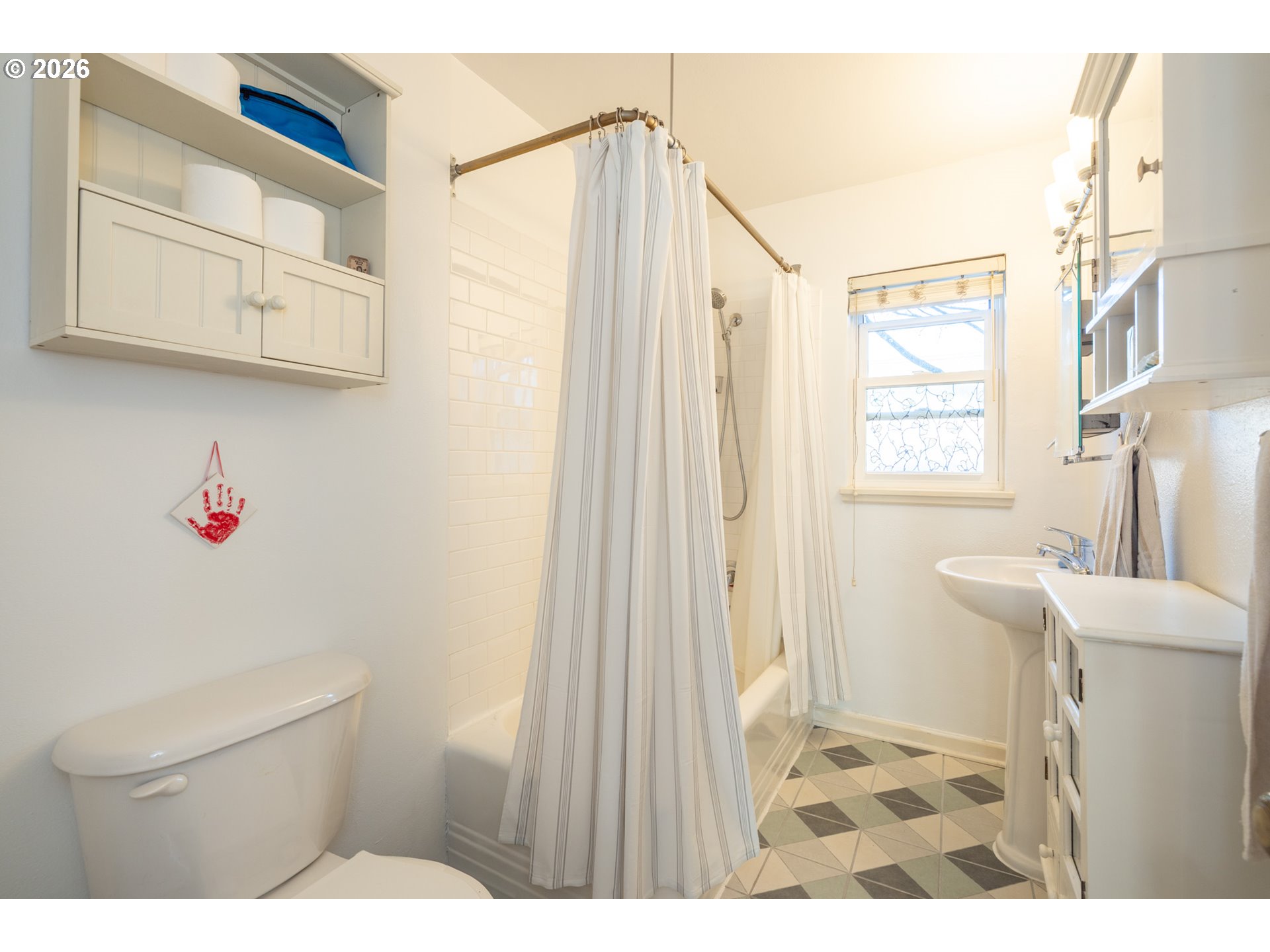 2123 Northeast Clackamas Street, Unit 5 Portland, OR 97232 - Photo 22 of 31 a bathroom with a sink and a shower curtain