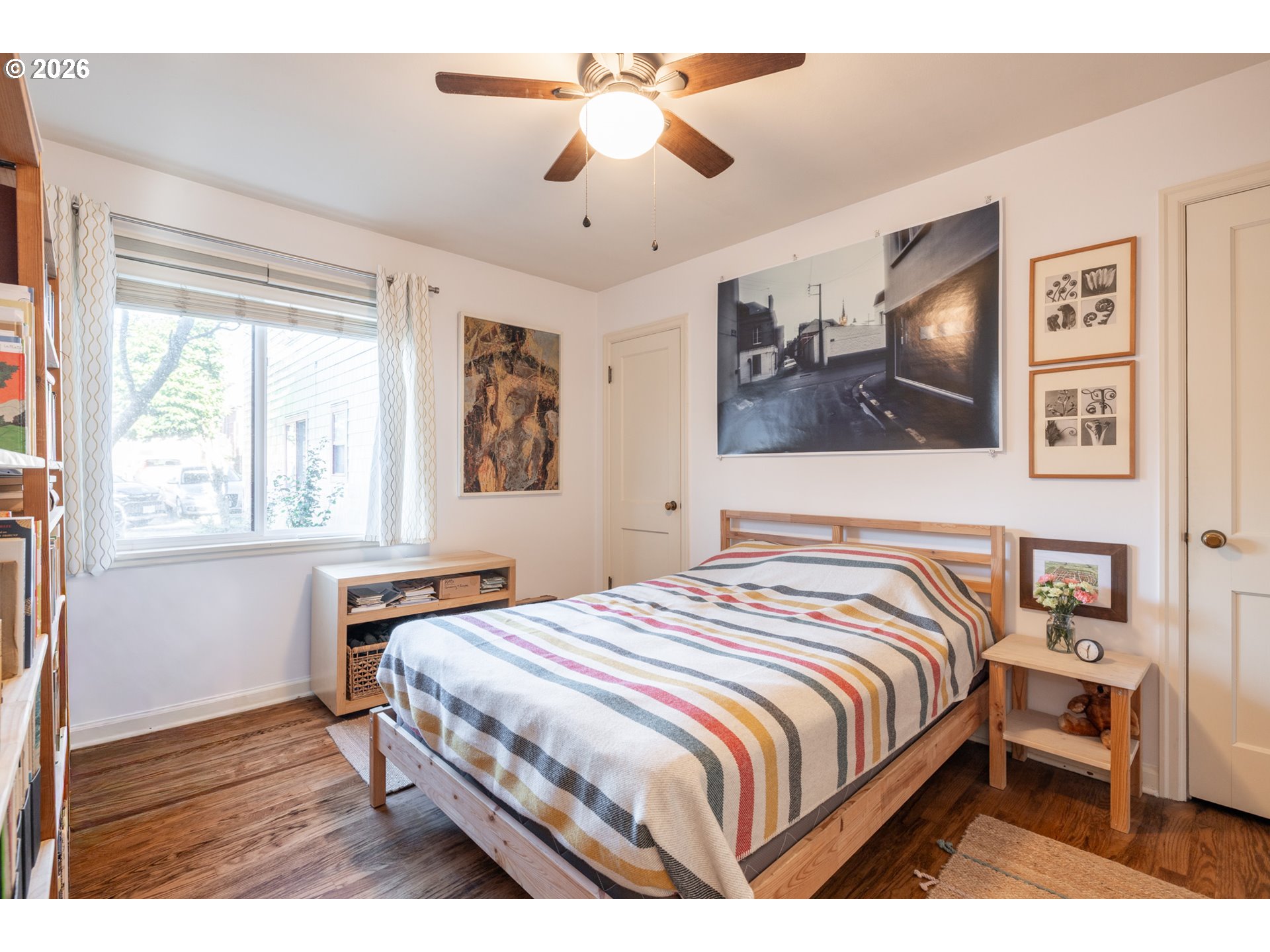 2123 Northeast Clackamas Street, Unit 5 Portland, OR 97232 - Photo 24 of 31 a bedroom with a bed and a chandelier
