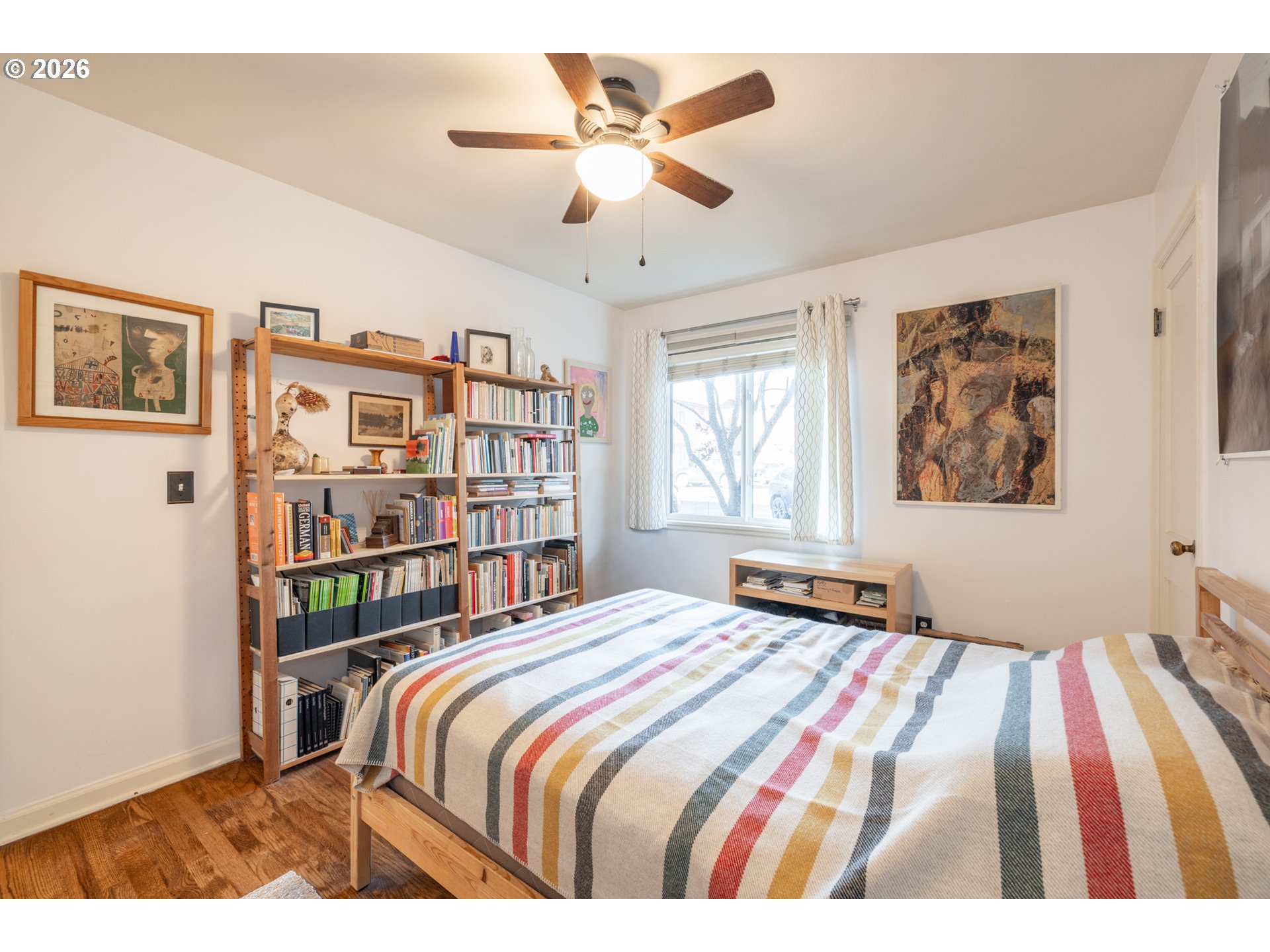 2123 Northeast Clackamas Street, Unit 5 Portland, OR 97232 - Photo 25 of 31 a bedroom with a bed a window and a book shelf
