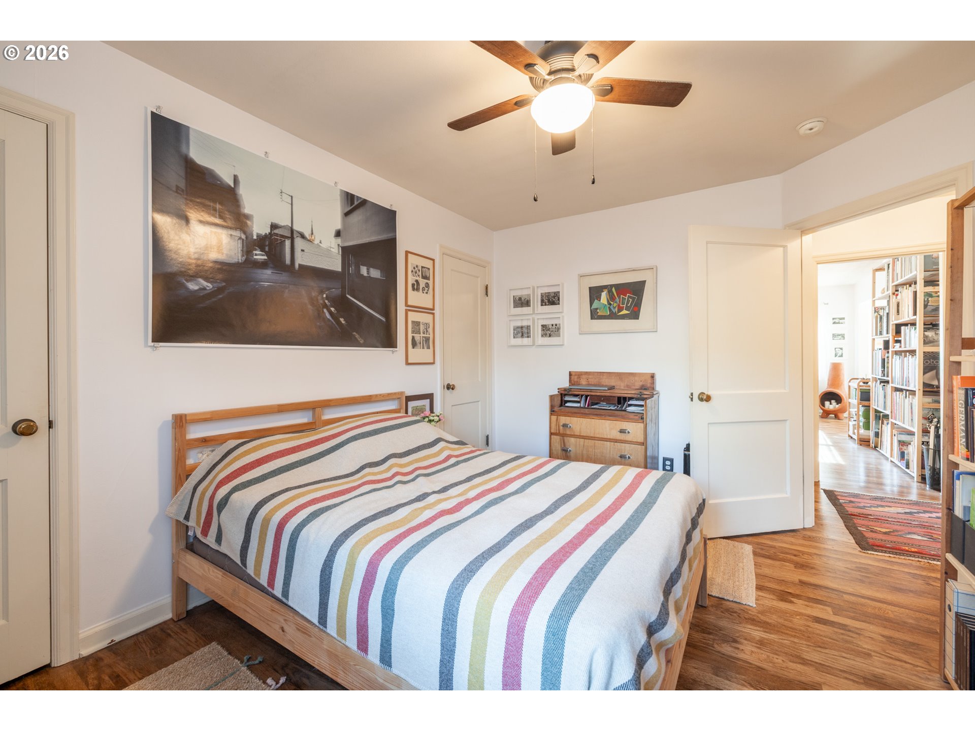 2123 Northeast Clackamas Street, Unit 5 Portland, OR 97232 - Photo 26 of 31 a bedroom with a bed and a chandelier