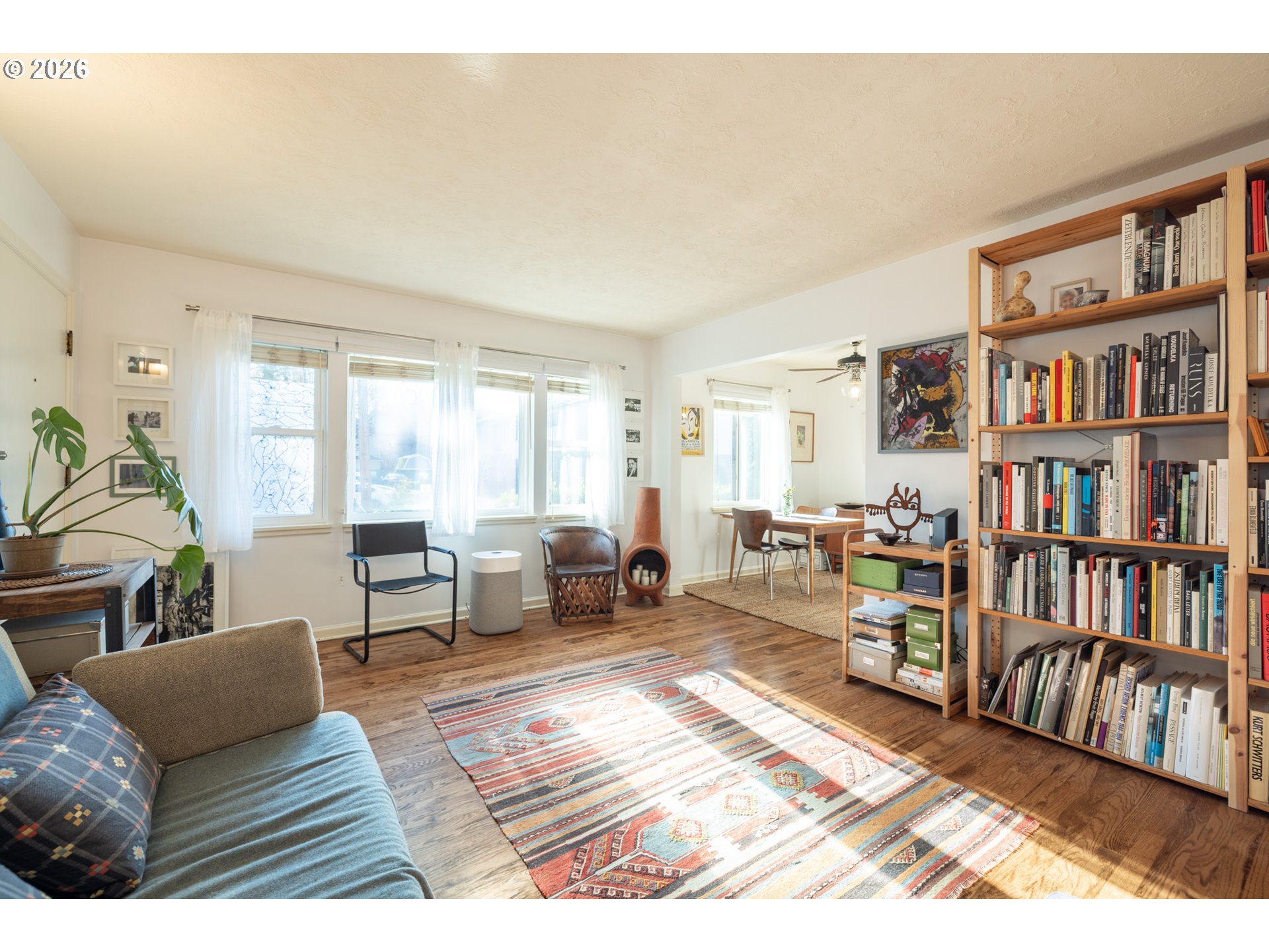 2123 Northeast Clackamas Street, Unit 5 Portland, OR 97232 - Photo 8 of 31 a living room with furniture and a book shelf