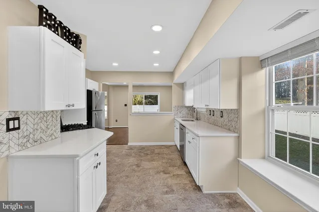 a kitchen with a sink stove and refrigerator