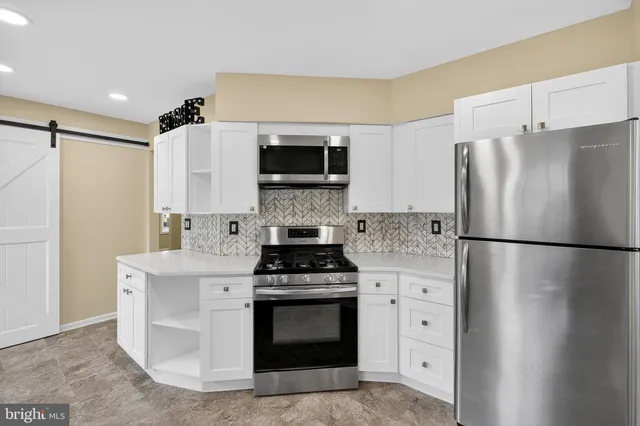 a kitchen with a refrigerator stove and microwave