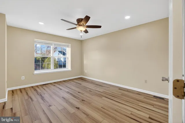 wooden floor in an empty room with a window