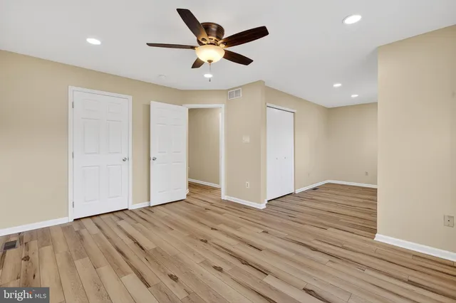 a view of empty room with wooden floor