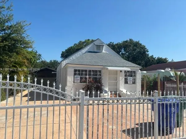 a front view of house with yard outdoor seating and barbeque oven
