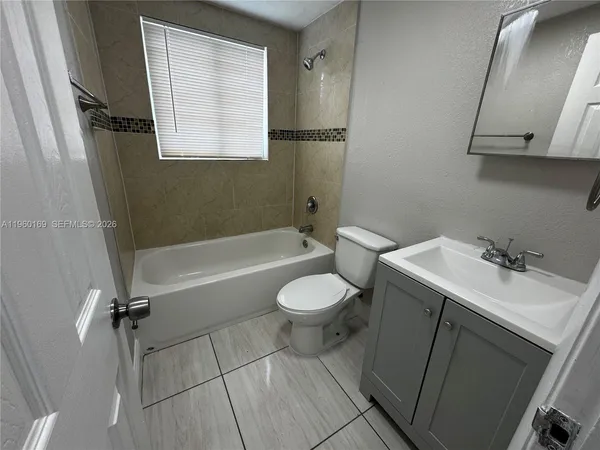 a bathroom with a sink a toilet and a bathtub
