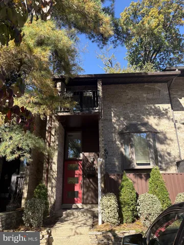 a view of backyard with outdoor seating and trees